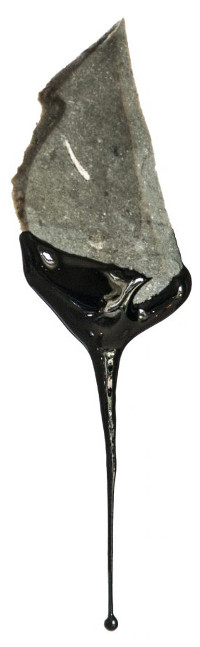 Tar produced from the experiment seen dripping from a flint flake. (Image: Paul Kozowyk)